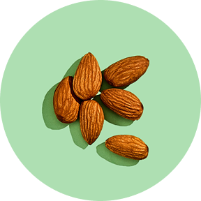 Seven almonds on a light green circular background.