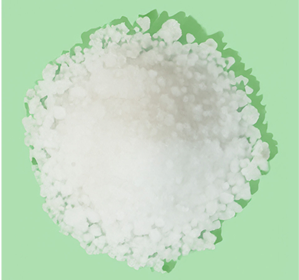 A pile of coarse white salt on a green background.