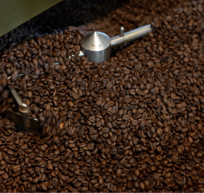 Freshly roasted coffee beans cooling in a machine.